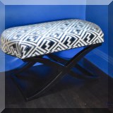 F08. Upholsted crossed leg ottoman. 18”h x 34”w x 19”d 
